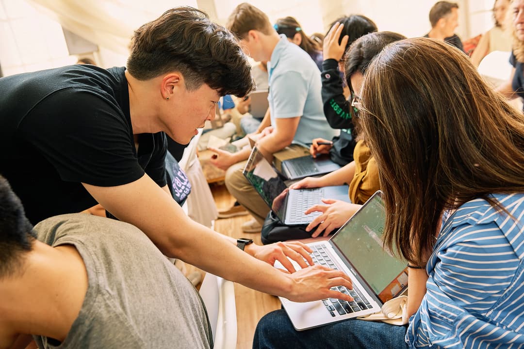 JM helping an attendee with their laptop during the workshop