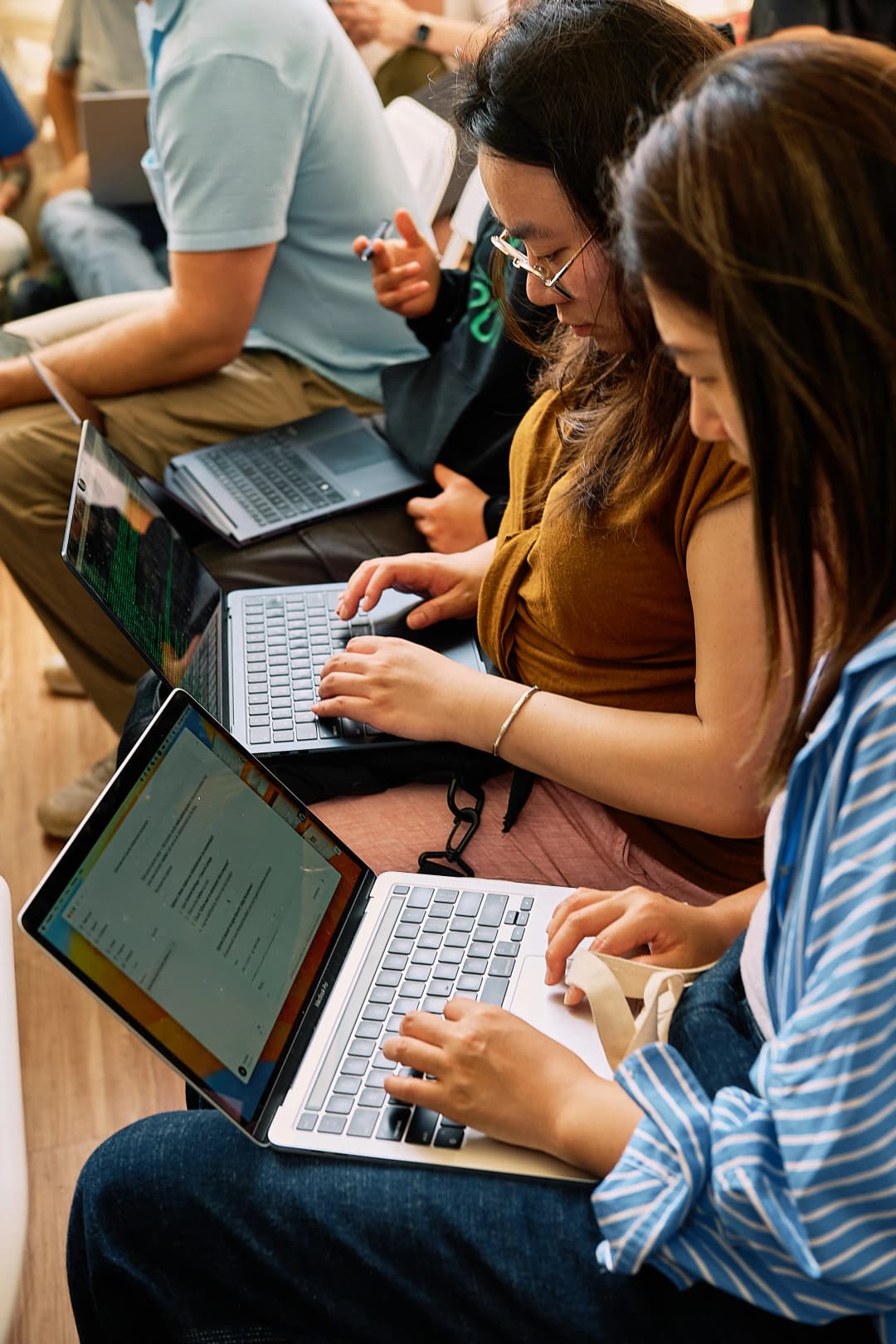 Attendees typing on laptops side by side during the workshop