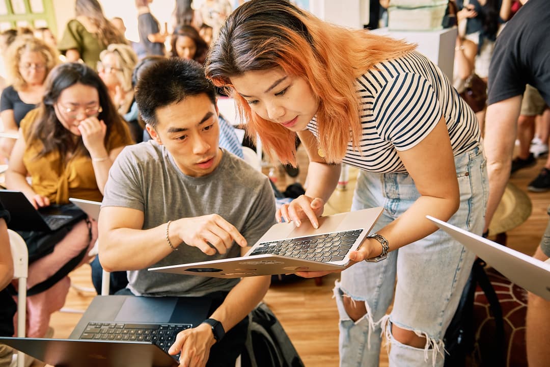 Two attendees debugging a setup together