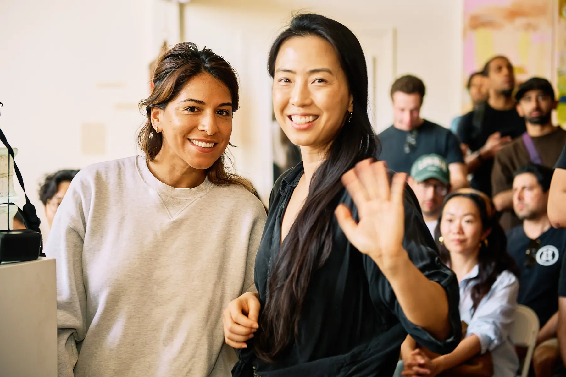 Two attendees smiling and waving at the OpenClaw LA Meetup #2