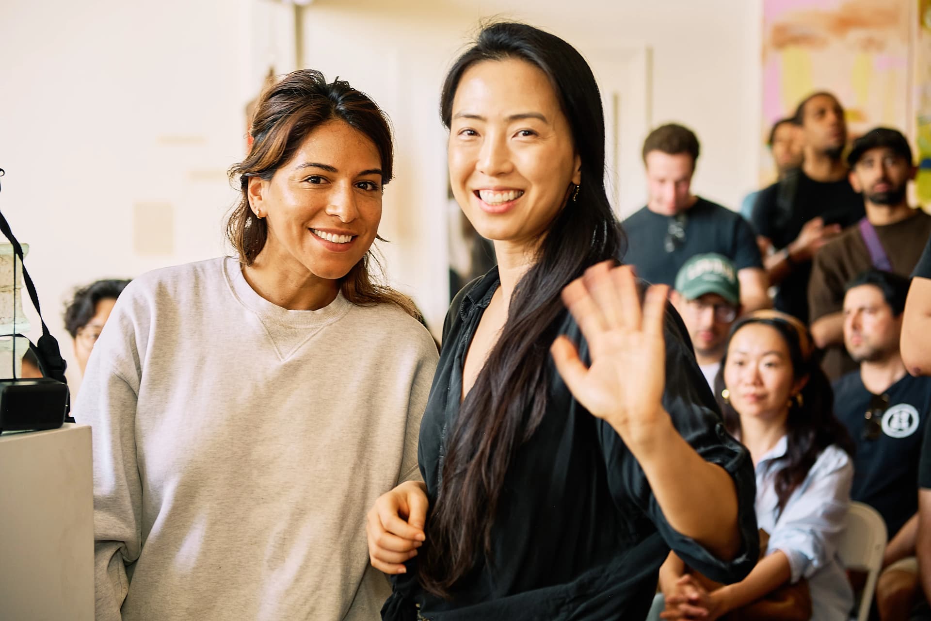 Two attendees smiling and waving at the OpenClaw LA Meetup #2