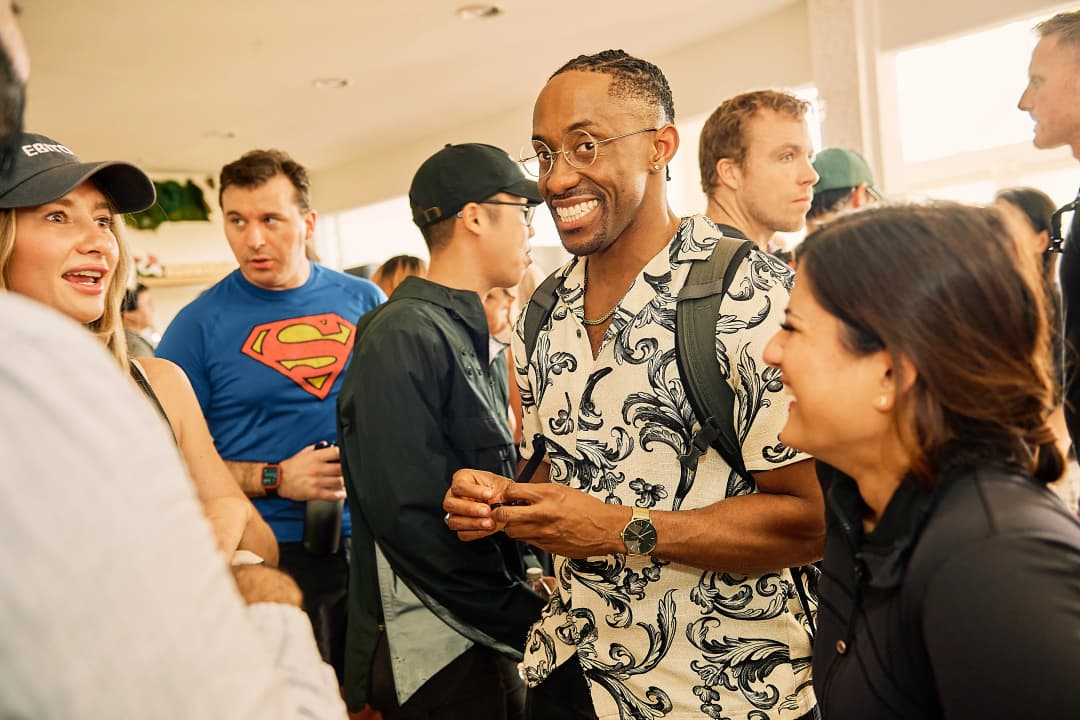 Attendees mingling and laughing after demos