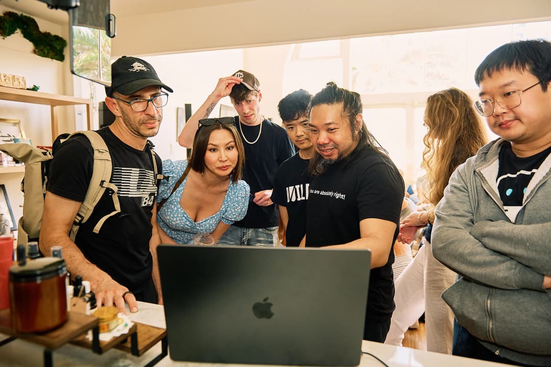 Group huddled around a laptop after the event