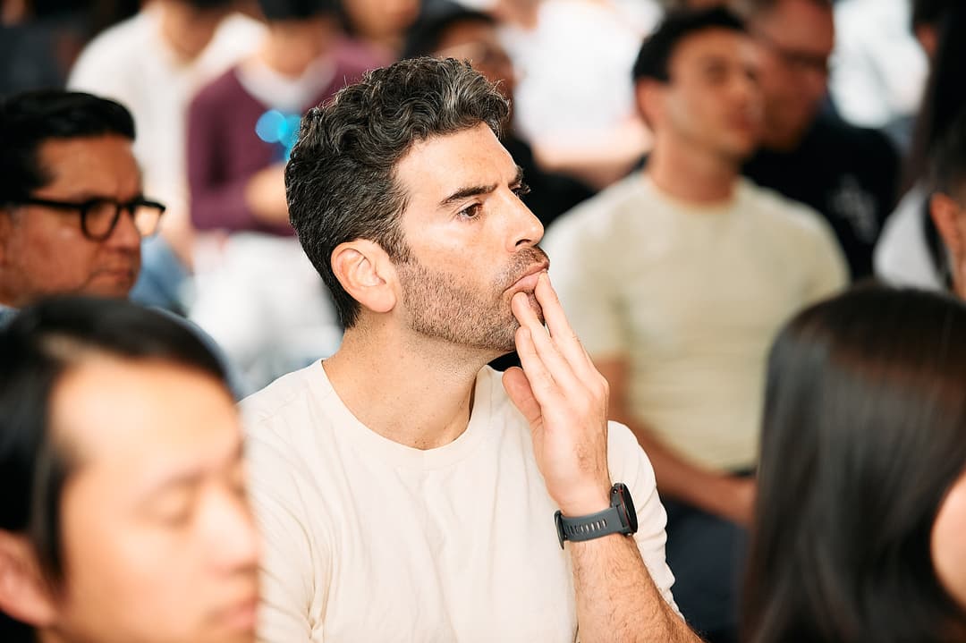 Attendee listening intently during a demo
