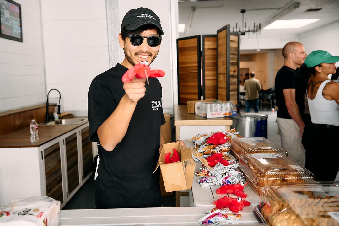 Attendee handing out lobster plushies at the snack table