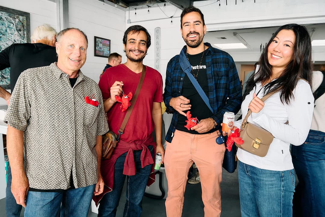 Group of attendees holding lobster plushies in the lobby
