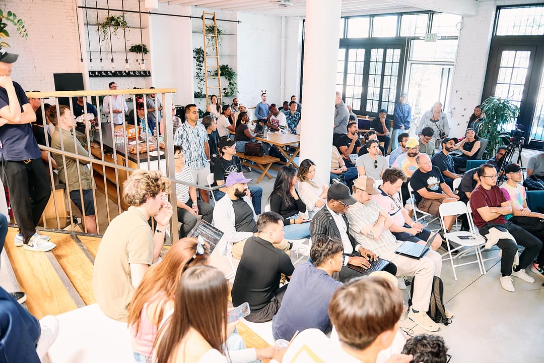 Wide view of the seated audience during a demo
